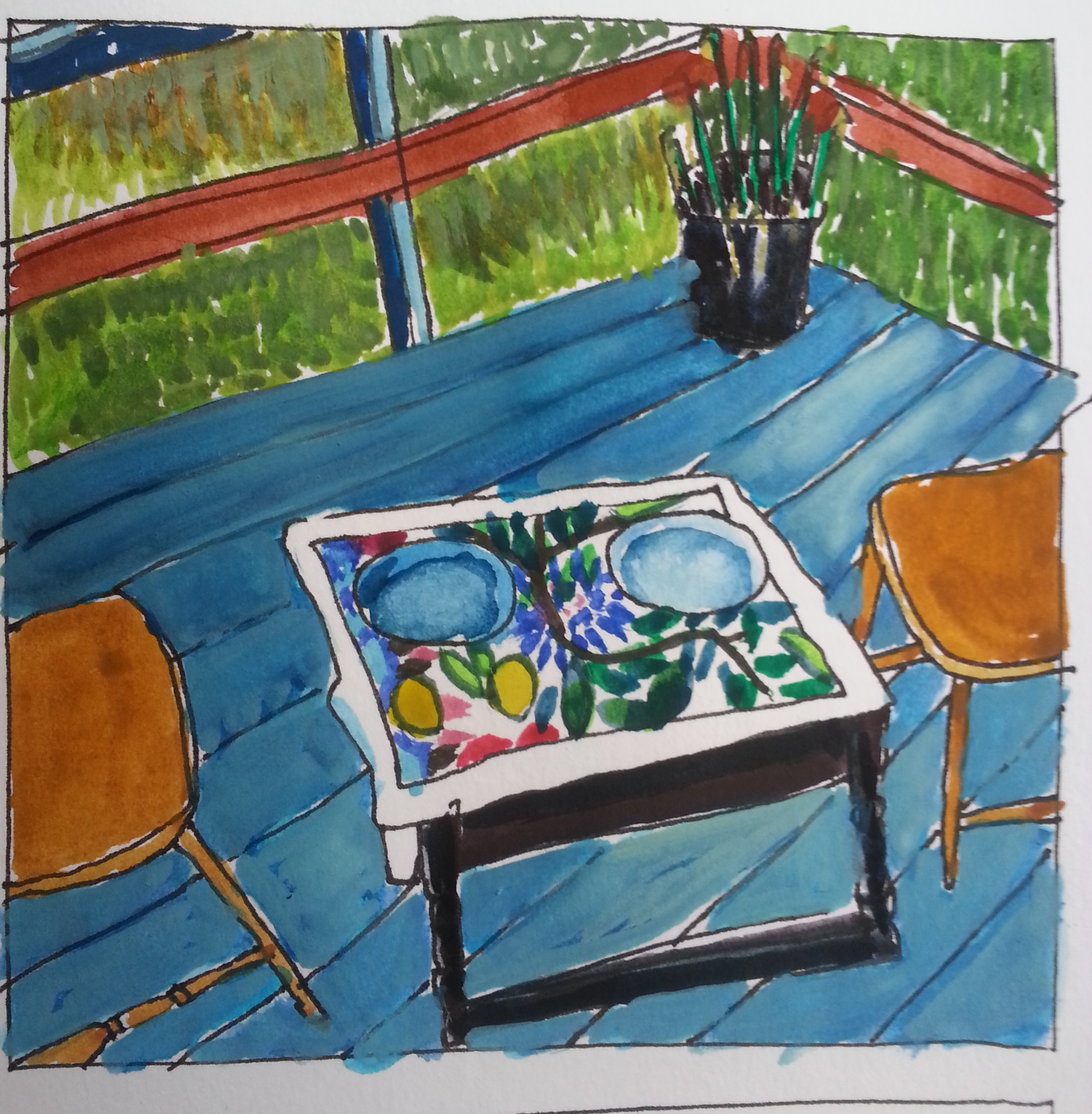 small table on porch with two blue plates